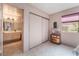 Bedroom with a view to bathroom, featuring pink walls and neutral floors at 2857 San Lago Ct, Las Vegas, NV 89121
