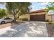 Charming home featuring a spacious driveway and a two-car garage with a well-maintained front yard at 2857 San Lago Ct, Las Vegas, NV 89121