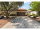 Charming home featuring a spacious driveway and a two-car garage with a well-maintained front yard at 2857 San Lago Ct, Las Vegas, NV 89121