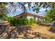 Beautiful home featuring lush landscaping, mature trees, and a well-maintained exterior at 2857 San Lago Ct, Las Vegas, NV 89121