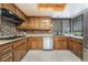 Well-appointed kitchen with stainless steel appliances, wooden cabinets, and tiled backsplash at 2857 San Lago Ct, Las Vegas, NV 89121