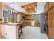 Modern kitchen featuring wooden cabinets, stainless steel appliances, and a breakfast bar at 2857 San Lago Ct, Las Vegas, NV 89121