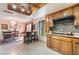Bright eat-in kitchen featuring tile floors, wood cabinets and a breakfast bar with seating at 2857 San Lago Ct, Las Vegas, NV 89121