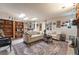 Comfortable living room featuring tile floors, recessed lighting and a brick fireplace at 2857 San Lago Ct, Las Vegas, NV 89121
