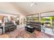 Bright living room with vaulted ceilings, tile floors, and access to the backyard at 2857 San Lago Ct, Las Vegas, NV 89121