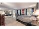 Main bedroom featuring plush carpeting, a large bed, and ensuite bathroom at 2857 San Lago Ct, Las Vegas, NV 89121