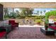 Relaxing covered patio with outdoor seating and well-manicured landscaping at 2857 San Lago Ct, Las Vegas, NV 89121