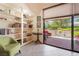 Cozy sitting area with built-in bookshelves and a sliding glass door to the patio at 2857 San Lago Ct, Las Vegas, NV 89121