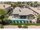 Aerial view of a home with a backyard pool, covered patio, and beautifully landscaped yard at 3042 Soft Horizon Way, Las Vegas, NV 89135