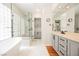 Luxurious bathroom featuring a soaking tub, glass shower, and dual vanities at 3042 Soft Horizon Way, Las Vegas, NV 89135