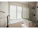 Beautiful bathroom featuring a soaking tub and glass shower with modern fixtures at 3042 Soft Horizon Way, Las Vegas, NV 89135