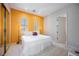 Bright bedroom featuring large closet, carpeted floors, and bright yellow accent wall with two windows at 3042 Soft Horizon Way, Las Vegas, NV 89135