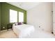 Bedroom featuring carpeted floors, light walls, and a green accent wall with two windows at 3042 Soft Horizon Way, Las Vegas, NV 89135