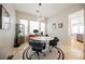 Dining area with modern light fixture, round table, and access to kitchen at 3042 Soft Horizon Way, Las Vegas, NV 89135