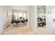 Bright dining area with modern lighting, tile flooring, and a mirrored wet bar at 3042 Soft Horizon Way, Las Vegas, NV 89135