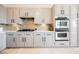 Modern kitchen with stainless appliances, white countertops, and custom cabinets at 3042 Soft Horizon Way, Las Vegas, NV 89135