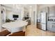 Open kitchen with granite countertops, stainless steel refrigerator and a crystal chandelier at 3042 Soft Horizon Way, Las Vegas, NV 89135