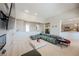 Open living room with fireplace and plush sofa with an open design at 3042 Soft Horizon Way, Las Vegas, NV 89135