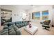 Bright living room featuring a modern plush sofa, marble table, and balcony access at 3042 Soft Horizon Way, Las Vegas, NV 89135