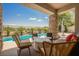 Covered patio featuring stylish seating and stone columns, offering a serene outdoor space at 3042 Soft Horizon Way, Las Vegas, NV 89135