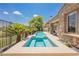 Backyard pool with integrated hot tub and well-manicured desert landscaping; relaxation and luxury at 3042 Soft Horizon Way, Las Vegas, NV 89135