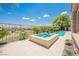 Inviting pool and hot tub featuring a stone surround and well-manicured landscaping at 3042 Soft Horizon Way, Las Vegas, NV 89135