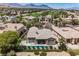 A gorgeous backyard with a pool, patio, and a view of the mountains at 3042 Soft Horizon Way, Las Vegas, NV 89135