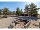 Expansive backyard with fire pit and mature landscaping at 3580 S Shawnee Ave, Pahrump, NV 89048
