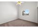 Bedroom featuring neutral carpeting, a ceiling fan, and a bright window at 3580 S Shawnee Ave, Pahrump, NV 89048