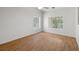 Bright bedroom with wood floors and large window overlooking the backyard at 3580 S Shawnee Ave, Pahrump, NV 89048