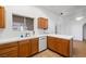 Bright kitchen with tile counters, wood cabinets, and a window overlooking the backyard at 3580 S Shawnee Ave, Pahrump, NV 89048