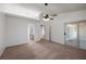 Spacious main bedroom with plush carpeting, ceiling fan, and sliding glass door at 3580 S Shawnee Ave, Pahrump, NV 89048