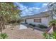 Backyard featuring low maintenance landscaping, mature trees, and a covered patio area for outdoor enjoyment at 3640 Snowy Pines St, Las Vegas, NV 89147