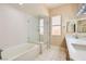 Bright bathroom featuring dual sinks, a bathtub, and a separate glass-enclosed shower at 3640 Snowy Pines St, Las Vegas, NV 89147
