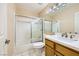 Bright bathroom featuring a shower-tub combination with sliding doors and a modern vanity with marble countertop at 3640 Snowy Pines St, Las Vegas, NV 89147