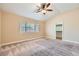 Spacious carpeted bedroom with ceiling fan, closet, and large window offering natural light at 3640 Snowy Pines St, Las Vegas, NV 89147