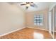 Cozy bedroom with hardwood floors, ceiling fan, and a window for natural light at 3640 Snowy Pines St, Las Vegas, NV 89147