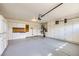 Spacious garage with built-in storage cabinets, epoxy flooring, and plenty of room for vehicles and projects at 3640 Snowy Pines St, Las Vegas, NV 89147