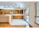 Eat-in kitchen featuring oak cabinetry, stainless steel appliances, and sliding glass doors to the patio at 3640 Snowy Pines St, Las Vegas, NV 89147