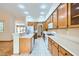 Well-lit kitchen equipped with white appliances, ample counter space, and wood cabinets for storage at 3640 Snowy Pines St, Las Vegas, NV 89147