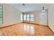 Bright living room featuring hardwood floors and multiple windows for ample natural light at 3640 Snowy Pines St, Las Vegas, NV 89147