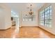 Open-concept layout with hardwood floors, large windows, and view to the kitchen at 3640 Snowy Pines St, Las Vegas, NV 89147