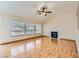 Bright and airy living room featuring hardwood floors, a fireplace, and large windows at 3640 Snowy Pines St, Las Vegas, NV 89147
