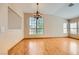 Spacious living room featuring hardwood floors, large windows, and a stylish chandelier at 3640 Snowy Pines St, Las Vegas, NV 89147