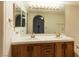 Bathroom featuring a double sink vanity, a large mirror with vanity lights, and tile countertops at 390 Montego Ln, Boulder City, NV 89005