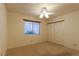 Bright bedroom features a ceiling fan, closet, and large window at 390 Montego Ln, Boulder City, NV 89005