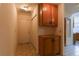 Hallway featuring overhead cabinets and a door for outdoor access at 390 Montego Ln, Boulder City, NV 89005