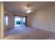 Carpeted living room with large windows and access to the outdoor patio area at 390 Montego Ln, Boulder City, NV 89005