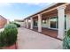 Covered patio with support pillars and tile flooring, offering a tranquil outdoor living space with lush greenery at 390 Montego Ln, Boulder City, NV 89005