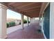 Covered patio with support pillars and tile flooring, blending seamlessly with the lush backyard garden landscape at 390 Montego Ln, Boulder City, NV 89005